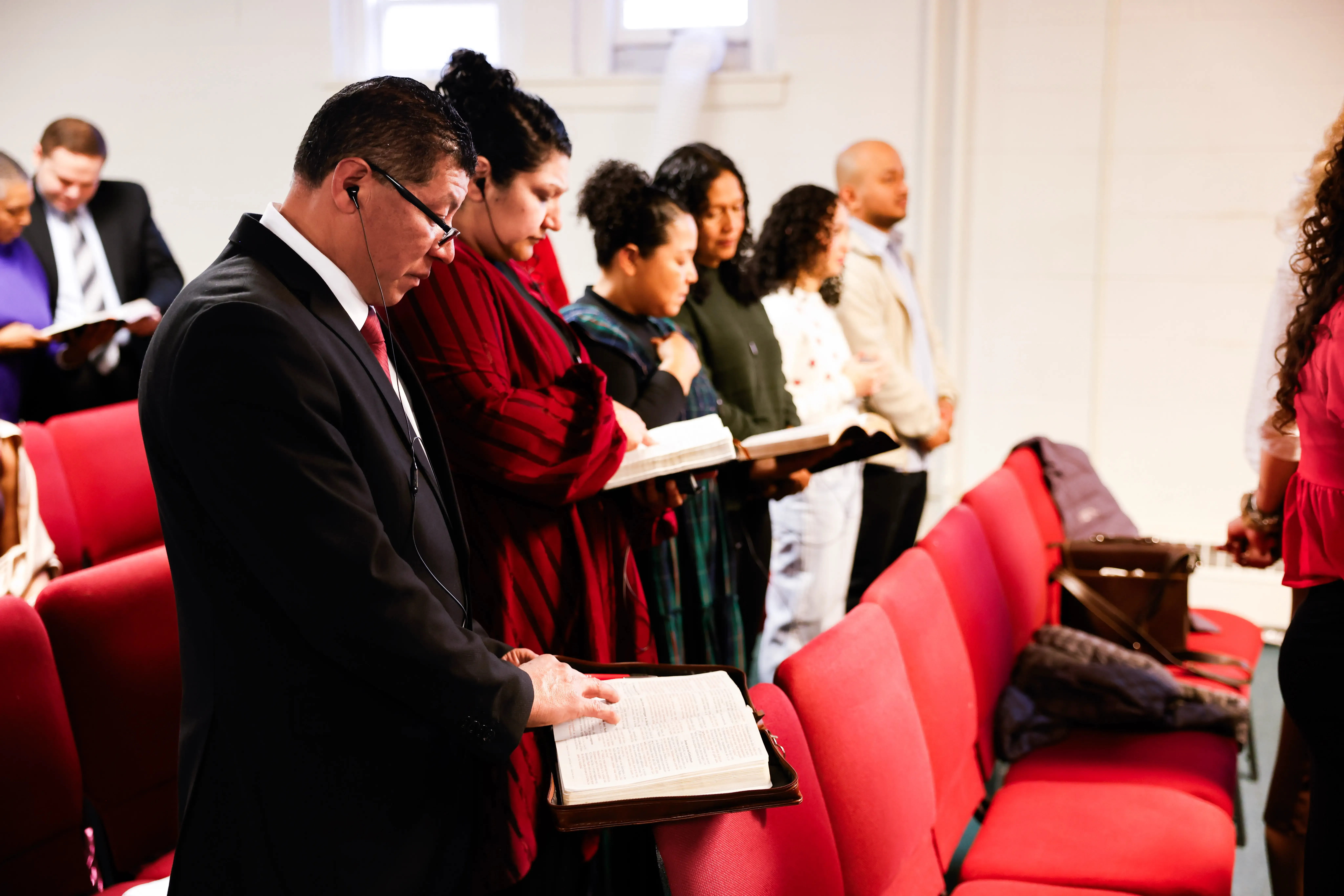 Congregants following along in their open Bibles during the message